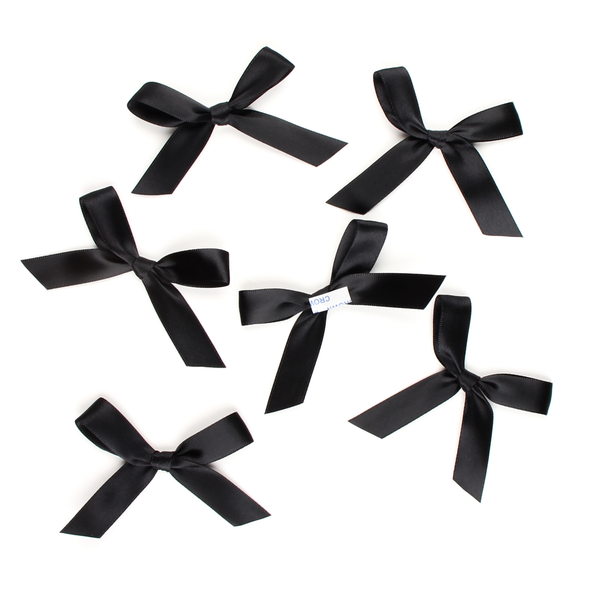Multiple black satin pre-tied bows by Lux Party, showing peel and stick backing.