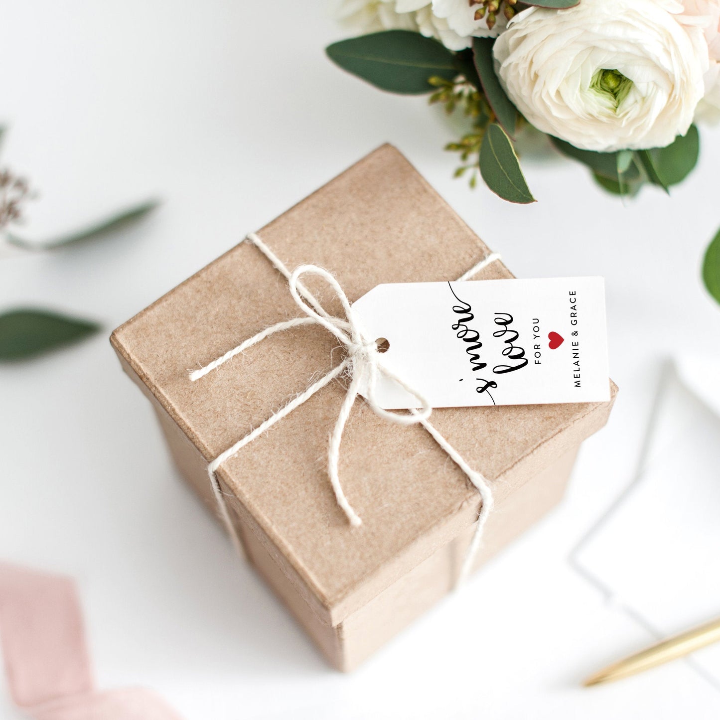Lux Party’s white s’more love wedding favor tag with black script and a red heart, tied to a brown kraft favor box.