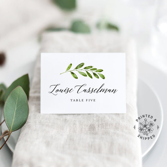 Lux Party’s greenery place cards with white background and black lettering, in a wedding table place setting.