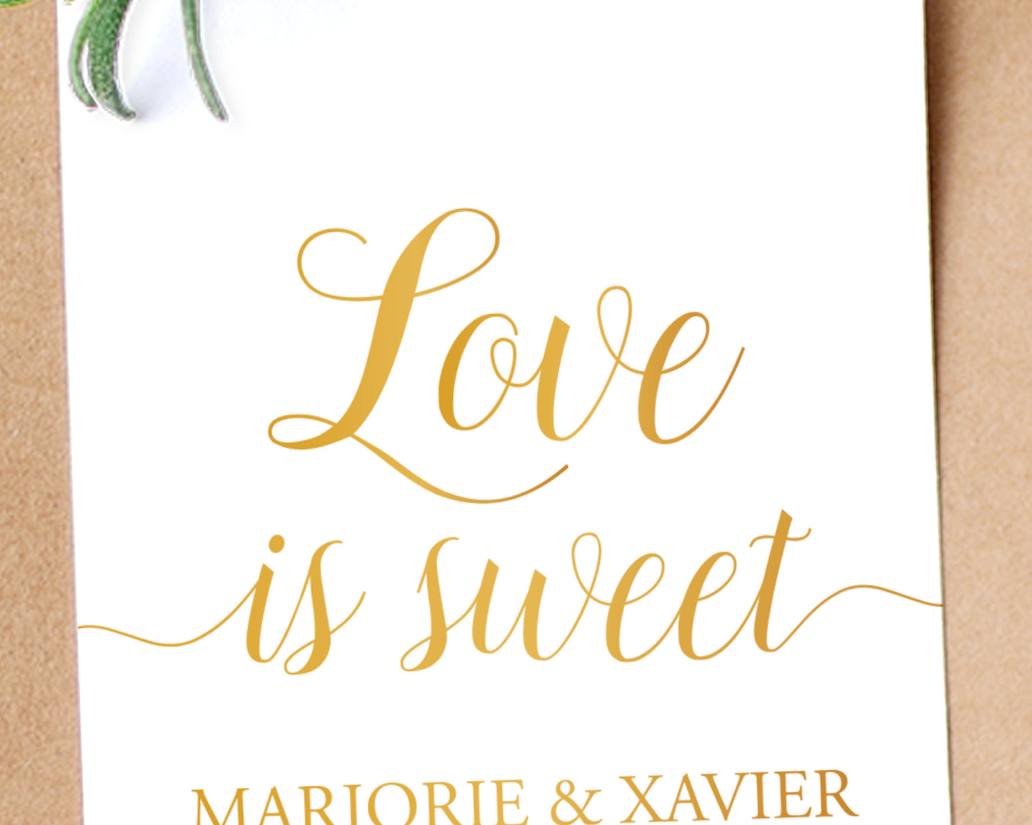 Close up of Lux Party’s white love is sweet wedding favor tag with gold script, affixed to a brown kraft favor bag.
