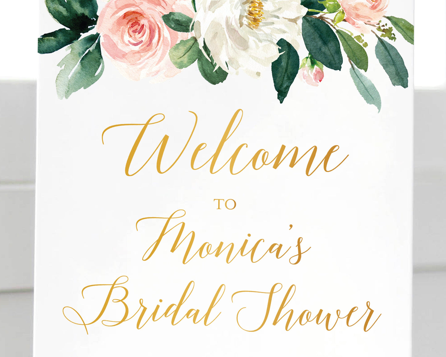 Close up of Lux Party’s bridal shower welcome sign, with pastel flowers and gold lettering.
