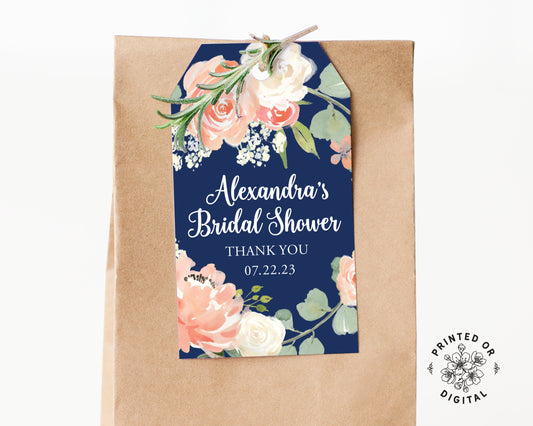 Lux Party’s navy blue bridal shower tag with white script and pastel flowers, affixed to a brown kraft favor bag.